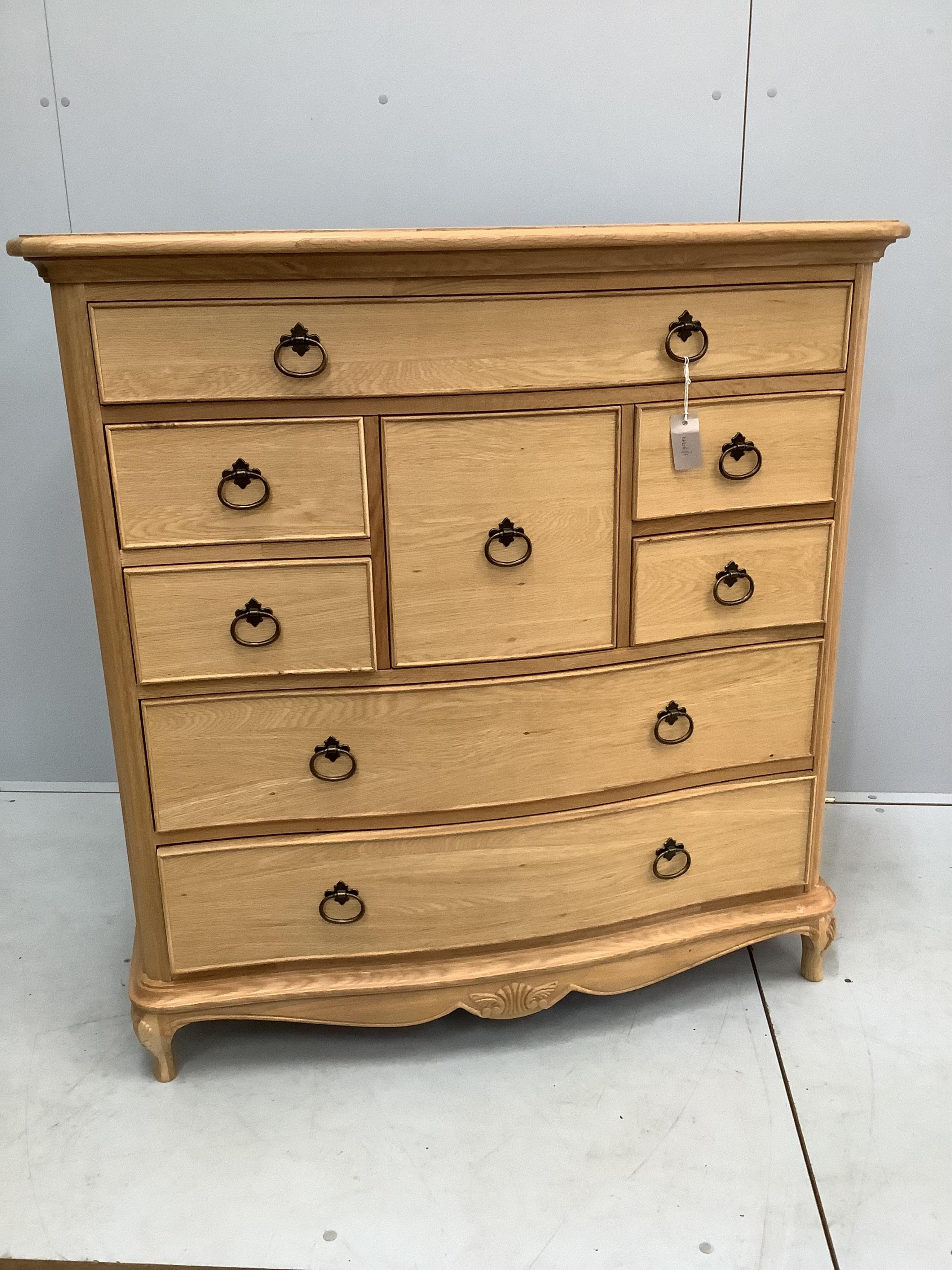 A Willis and Gambier Charlotte oak serpentine chest of eight drawers, width 108cm, depth 53cm, height 111cm